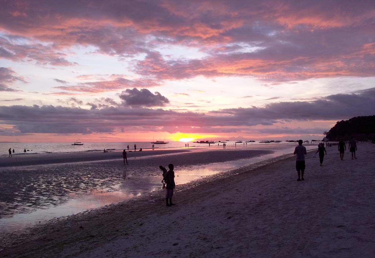 Sunset stroll on White Beach Boracay in Philippines